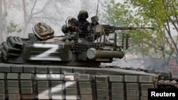 A service member of pro-Russian troops is seen atop a tank during fighting in Ukraine-Russia conflict near the Azovstal steel plant in the southern port city of Mariupol, Ukraine May 5, 2022.