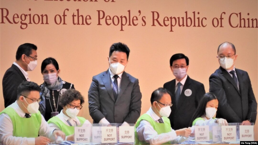 今屆特首選舉唯一候選人李家超(後排右二)在場觀察工作人員點票。(美國之音/湯惠芸)