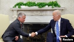 FILE - U.S. President Joe Biden shakes hands with Jordan's King Abdullah in the Oval Office at the White House in Washington, July 19, 2021. 
