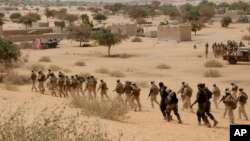 FILE- In this Saturday March 7, 2015 file photo, Chadian troops and Nigerian special forces participate in the Flintlock exercises with the U.S. military and its Western partners in Mao, Chad. 