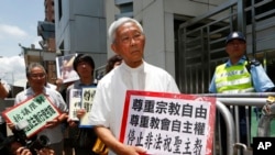 FILE - Cardinal Joseph Zen, center, and other religious protesters hold placards with 'Respects religious freedom' written on them during a demonstration outside the China Liaison Office in Hong Kong, July 11, 2012.