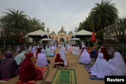 FILE - Muslims celebrate Eid al-Fitr, the Muslim festival marking the end of the holy fasting month of Ramadan, at a mosque amid the spread of the coronavirus disease (COVID-19) outbreak in Pattani province, Thailand, May 24, 2020.