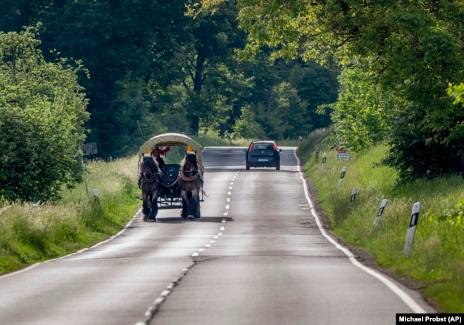 Horse farmer Stephanie Kirchner drives her carriage on a road near her hometown Schupbach, Germany, May 19, 2022. (AP Photo/Michael Probst)