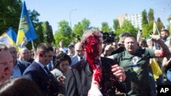 Russian Ambassador to Poland, Ambassador Sergey Andreev is covered with red paint in Warsaw, Poland, May 9, 2022. 