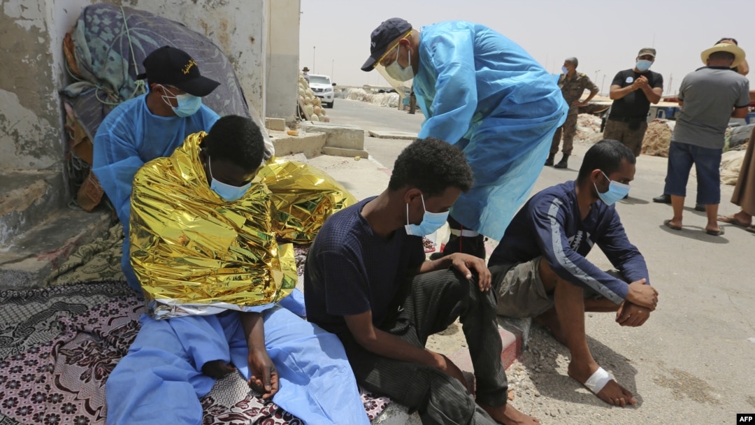 ARCHIVES - Des migrants secourus par la garde nationale tunisienne lors d'une tentative de traversée de la Méditerranée en bateau se reposent au port d'el-Ketef dans le sud de la Tunisie, près de la frontière avec la Libye, le 27 juin 2021.
