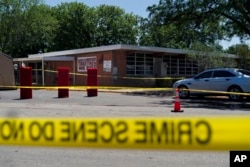 Crime scene tape surrounds Robb Elementary School in Uvalde, Texas, May 25, 2022. (AP Photo/Jae C. Hong)