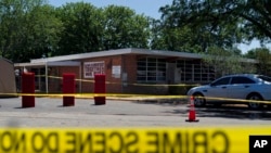 Crime scene tape surrounds Robb Elementary School in Uvalde, Texas, May 25, 2022.