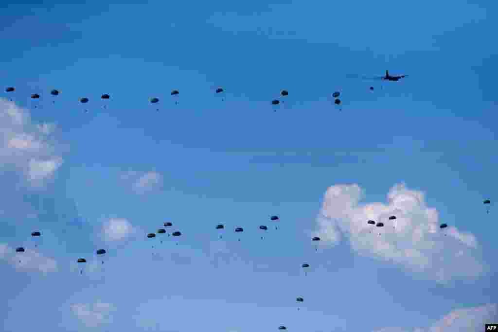 Italian paratroopers jump from an airplane during the Swift Response 22 military exercise at the Krivolak Military Training Center in Negotino, in the center of North Macedonia.