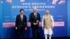 Japanese Prime Minister Fumio Kishida, left, U.S. President Joe Biden and Indian Prime Minister Narendra Modi pose for photos as they arrive at the Indo-Pacific Economic Framework for Prosperity launch event at the Izumi Garden Gallery, May 23, 2022, in Tokyo.