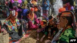 Kalash tribe women wearing traditional dresses arrive to take part in the &#39;Chilam Joshi&#39; festival celebrating the arrival of spring at Bumburet village, Pakistan.