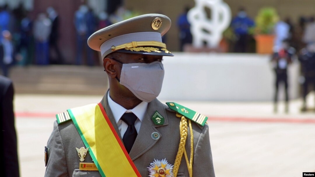 FILE - Colonel Assimi Goita, leader of two military coups, walks during the inauguration ceremony making him Mali's new interim president, in Bamako, Mali June 7, 2021.