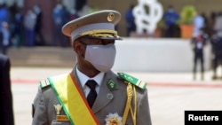 FILE - Colonel Assimi Goita, leader of two military coups, walks during the inauguration ceremony making him Mali's new interim president, in Bamako, Mali June 7, 2021.