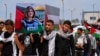 FILE - Palestinian students carry a mock coffin as they hold a symbolic funeral for slain Al Jazeera journalist Shireen Abu Akleh, at al-Azhar University in Mughraqa, central Gaza Strip, May 16, 2022. 