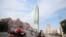 FILE - People ride past Taipei 101 building in Taipei, Taiwan, Saturday, May 15, 2021. A strong earthquake struck off the east coast of Taiwan on Monday, shaking buildings in the capital, Taipei.
