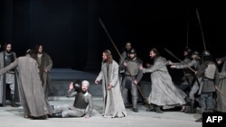 FILE - Frederik Mayet as Jesus (C) and ensemble members perform during a rehearsal at Oberammergau's Passion Play theatre in Oberammergau, southern Germany on May 4, 2022.