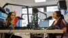 Melanie Nagy, left, and Szandi Minzari, right, hosts of Radio Dikh's women's show 'Zsa Shej' work together in a radio studio in Budapest, Hungary, May 6, 2022. 