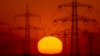 The sun rises behind power poles in the outskirts of Frankfurt, Germany, May 15, 2022. 