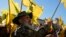 FILE - A Hezbollah fighter waves his group's flag as he attends an election rally in a southern suburb of Beirut, Lebanon, May 10, 2022.