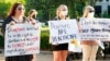 Women hold signs in support of abortion rights as they listen to speeches during a protest in support of legalized abortion at the Mississippi Capitol in Jackson, Miss., May 6, 2022. 
