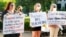 Women hold signs in support of abortion rights as they listen to speeches during a protest in support of legalized abortion at the Mississippi Capitol in Jackson, Miss., May 6, 2022. 