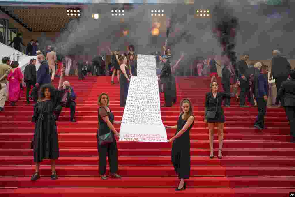 A banner is unveiled with a list of names and that reads at the end &quot;129 feminicides since the last Cannes festival&quot; at the premiere of the film &#39;Holy Spider&#39; at the 75th international film festival, Cannes, southern France.