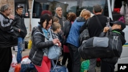 Civilians evacuate in Soledar, Donetsk region, Ukraine, May 24, 2022.