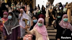 FILE - Muslims celebrate Eid al-Fitr, the Muslim festival marking the end of the holy fasting month of Ramadan, at the Thai Islamic Center amid the spread of the coronavirus disease (COVID-19) outbreak in Bangkok, Thailand, May 24, 2020. 