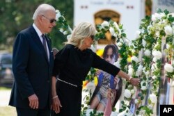 President Joe Biden and first lady Jill Biden visit a memorial at Robb Elementary School to pay their respects to the victims of the mass shooting, May 29, 2022, in Uvalde, Texas.