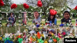 FILE - Flowers, toys, and keepsakes to remember the victims of the deadliest U.S. school shooting in nearly a decade. The victims are pictured at Robb Elementary School in Uvalde, Texas, May 30, 2022.
