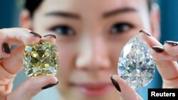 Returning for the third time since its mining in 1901, the "Red Cross" — a fancy intense yellow, cushion-shaped 205.07 carat diamond — and a 228.31 carat white diamond called "The Rock" that could fetch $30 million and is the largest ever seen throughout 