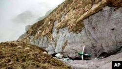 The wreckage of a plane lost in Nepal’s mountains was found scattered on a mountainside on May 30, 2022. Fourteen of the 22 people on board were confirmed dead, the army said. This handout photograph released by Fishtail Air, shows the wreckage of a plane