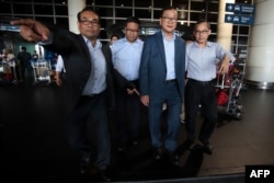 FILE - Cambodia's opposition leader in-exile Sam Rainsy (2nd R), who leads the Cambodia National Rescue Party (CNRP), arrives at the Kuala Lumpur International Airport in Sepang on November 9, 2019.