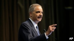 FILE - Former U.S. Attorney General Eric Holder Jr. speaks during the National Action Network Convention in New York. on April 3, 2019.