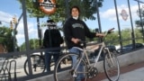 Anthony Jimenez-Galindo with his finished bike outside the Phoenix Bikes store. (Dan Novak/VOA)