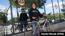 Anthony Jimenez-Galindo with his finished bike outside the Phoenix Bikes store. (Dan Novak/VOA)