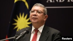 FILE - Malaysia's Foreign Minister Saifuddin Abdullah speaks during a news conference after ASEAN Summit in Kuala Lumpur, Malaysia, Oct. 28, 2021.
