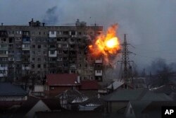 An apartment building explodes after a Russian army tank fires in Mariupol, Ukraine, March 11, 2022.