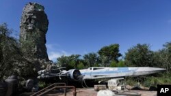 The X-Wing ship stands on display during a preview of the Star Wars themed land, Galaxy's Edge in Hollywood Studios at Disney World, in Lake Buena Vista, Florida, Aug. 27, 2019. The ship's designer, Colin Cantwell, died Saturday at his home in Colorado.