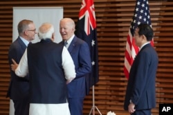 Leaders of Quadrilateral Security Dialogue (Quad) from left to right, Australian Prime Minister Anthony Albanese, Indian Prime Minister Narendra Modi, U.S. President Joe Biden, and Japanese Prime Minister Fumio Kishida at the entrance to the Prime Minister's Office of Japan in Tokyo, Tuesday, May 24, 2022. (Zhang Xiaoyu/Pool Photo via AP)