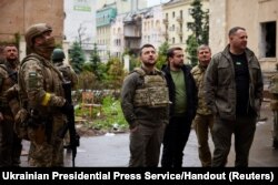 Ukraine's President Volodymyr Zelenskiyy visits an area damaged by Russian military strikes in Kharkiv, May 29, 2022.