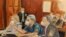 In this courtroom sketch, former Honduran President Juan Orlando Hernandez, center, speaks into a microphone while pleading not guilty to drug trafficking and weapons charges, May 10, 2022, in New York.