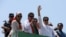Ousted Pakistani Prime Minister Imran Khan gestures as he travels on a vehicle to lead a protest march to Islamabad, in Mardan, Pakistan, May 25, 2022.