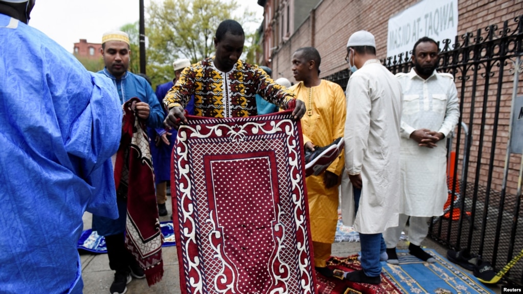 FILE - A man holds a prayer mat during the celebrations of Eid al-Fitr, at the Masjid At-Taqwa mosque, in the Brooklyn borough, in New York, May 2, 2022. The Council on American-Islamic Relations reported a rise in civil rights complaints from Muslims in the U.S. since 2020.