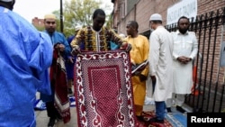 FILE - A man holds a prayer mat during the celebrations of Eid al-Fitr, at the Masjid At-Taqwa mosque, in the Brooklyn borough, in New York, May 2, 2022. The Council on American-Islamic Relations reported a rise in civil rights complaints from Muslims in the U.S. since 2020.