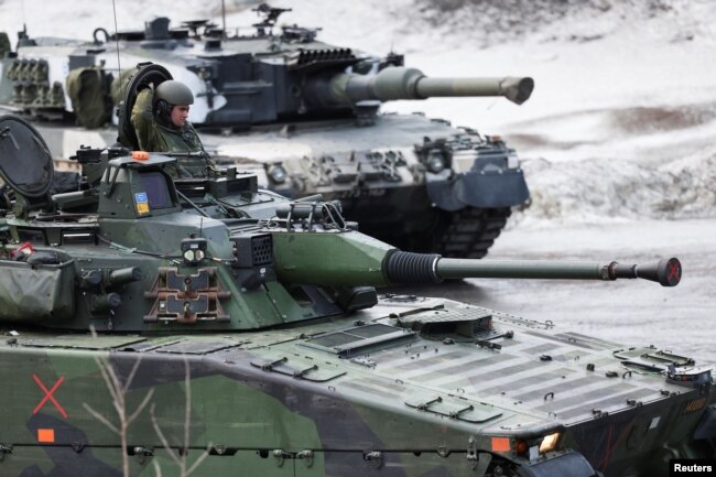 Swedish and Finnish tanks are seen during a military exercise called "Cold Response 2022", gathering around 30,000 troops from NATO member countries plus Finland and Sweden, amid Russia's invasion of Ukraine, in Evenes, Norway, March 22, 2022. (REUTERS/Yves Herman)