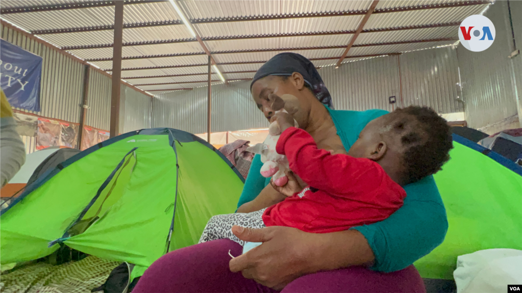 La haitiana Patricia Robert amamanta a su bebita en medio del albergue compuesto por carpas que ha sido su casa desde el 25 de diciembre de 2021, en el norte de Tijuana, cuando llegó buscando pedir asilo en Estados Unidos. Foto: Celia Mendoza, 7 de abril de 2022. Tijuana, México.