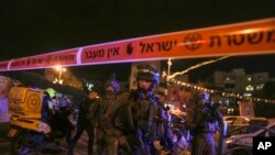 Israeli forces secure the area of a stabbing attack in the town of Elad, Israel, May 5, 2022. 
