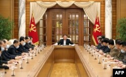 North Korean leader Kim Jong Un, center, attends the 8th political bureau meeting of the Workers Party of Korea in Pyongyang, in this picture taken and released from North Korea's official Korean Central News Agency.