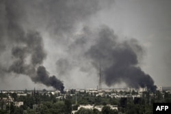 Smoke rises in the city of Sievierodonetsk during heavy fighting between Ukrainian and Russian troops in eastern Ukraine's Donbas region, May 30, 2022, on the 96th day of Russia's invasion of Ukraine.