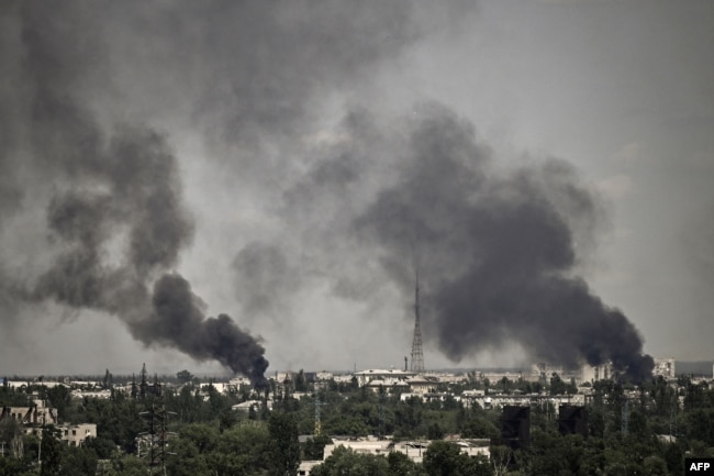 Smoke rises in the city of Sievierodonetsk during heavy fighting between Ukrainian and Russian troops in eastern Ukraine's Donbas region, May 30, 2022, on the 96th day of Russia's invasion of Ukraine.